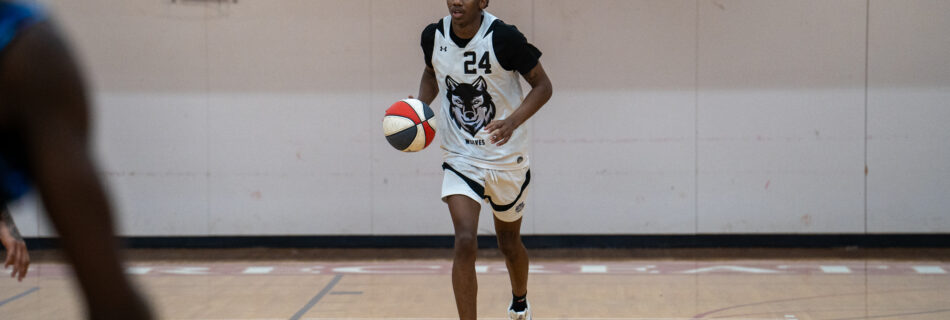 Dante Law, Massachusetts Wolves guard, dribbles past Providence Pirates defenders in a closely contested ABA basketball game in New Bedford, highlighting key action